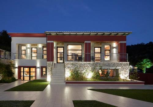 a large house with lights in front of it at Karvouno Villas in Sivota