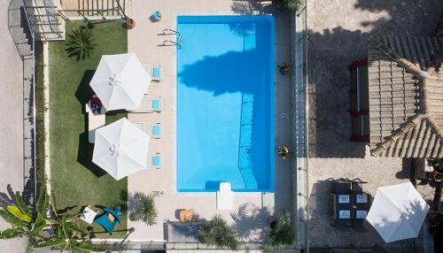an overhead view of a swimming pool with umbrellas at Karvouno Villas in Sivota