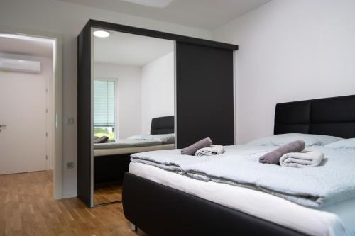 a bedroom with a large mirror and a bed at Villa de Roya in Rogaška Slatina