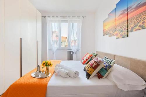 a bedroom with a white bed with pillows on it at Central Maya Apartment in Milan