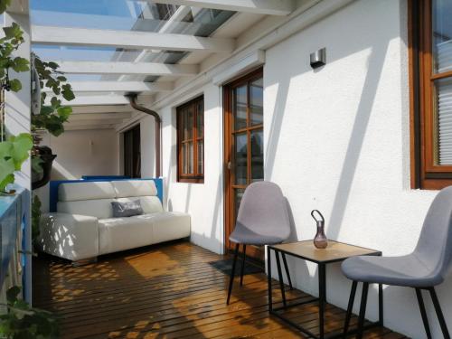 a living room with a couch and a table and chairs at Casa Kühnle in Friedrichshafen