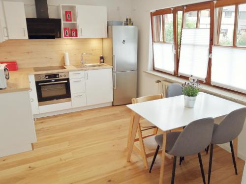 a kitchen with a white table and chairs in a kitchen at Casa Kühnle in Friedrichshafen