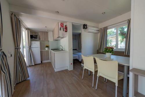 a kitchen and living room with a table and chairs at Club del Sole Stork Family Collection in Giulianova