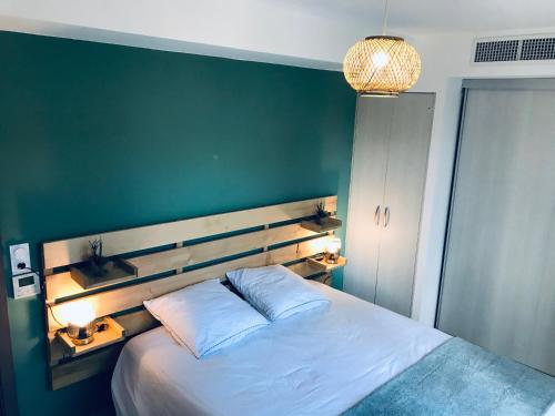 une chambre avec un grand lit avec un mur végétal dans l'établissement Résidence Standing Domaine d Arca, à Porto-Vecchio