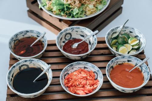 a group of bowls of food on a table at Phương Bắc Luxury Hotel in Dong Hoi
