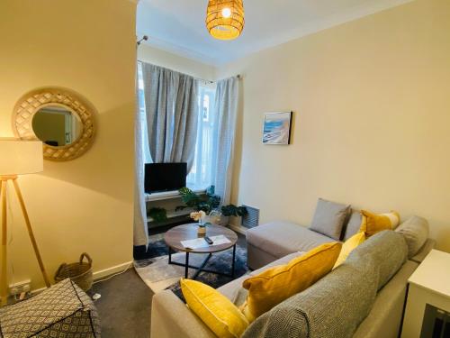 a living room with a couch and a table at Heart of Hastings Historic Old Town in Hastings