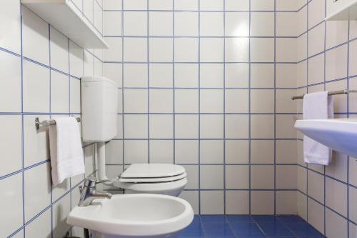 a bathroom with a white toilet and a sink at Podere Caprarecce Trilocale 6 in Talamone