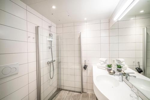 a bathroom with two sinks and a shower at Valldal Fjordhotell - by Classic Norway Hotels in Valldal