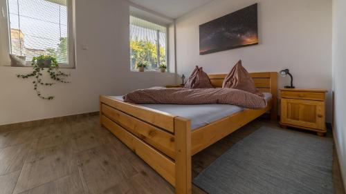 a bedroom with a wooden bed with pillows on it at Vila Familia in Turčianske Teplice