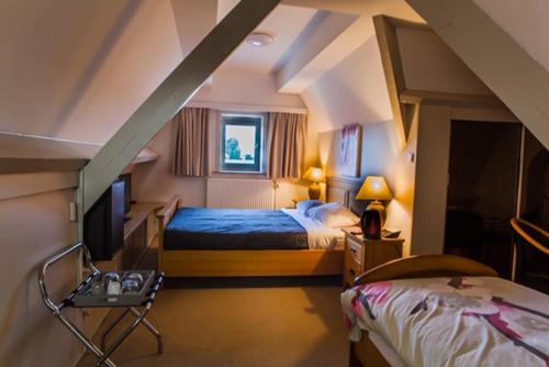 En eller flere senger på et rom på Hotel La Chaumiere