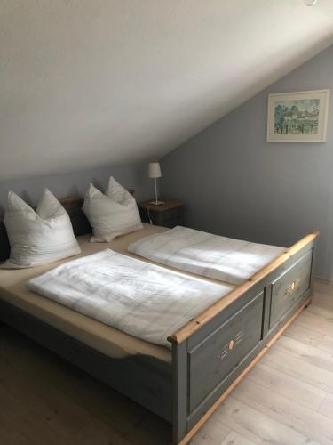 a bedroom with a large bed with white sheets at Bella Vista in Laufen