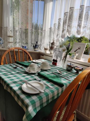 a table with a green and white checkered table cloth at Cameron court B&B in Flamborough