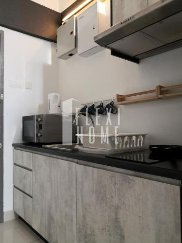 a kitchen with a counter top with a microwave at Pinnacle PJ, Romantic City View, 1-4 Guests Designed Duplex Home by Flexihome-MY in Petaling Jaya