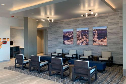 a waiting area in a hospital with chairs and tables at La Quinta Inn & Suites by Wyndham Holbrook Petrified Forest in Holbrook
