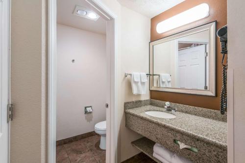 a bathroom with a sink and a toilet and a mirror at Quality Inn & Suites Downtown Walla Walla in Walla Walla