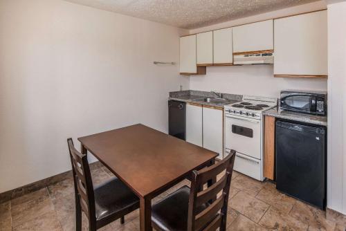a small kitchen with a table and a stove at Quality Inn & Suites Downtown Walla Walla in Walla Walla