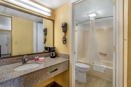 y baño con lavabo, aseo y espejo. en Econo Lodge Easton Route 50, en Easton