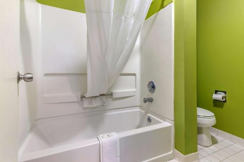 a bathroom with a white tub and a toilet at Quality Inn Brunswick in Brunswick