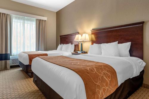 a hotel room with two beds and a window at Comfort Suites Biloxi/Ocean Springs in Biloxi