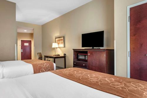 a hotel room with two beds and a flat screen tv at Comfort Suites Biloxi/Ocean Springs in Biloxi