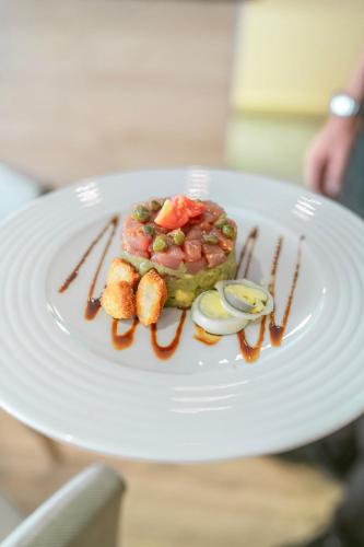 a white plate with food on top of it at Puerto Azul Marbella in Marbella