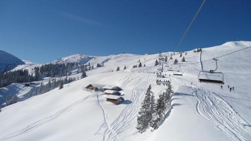a ski lift on a snow covered ski slope at Sonnenappartements Madlstatthof in Wildschönau