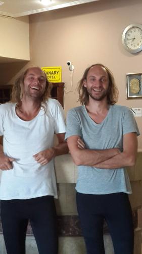 two men standing in a room with their arms crossed at Canary Hotel in Hurghada