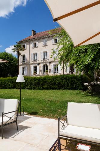 a patio with two chairs and a building at Domaine de Clairefontaine - Teritoria in Chonas-lʼAmballan