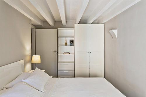 a bedroom with a bed and a white cabinet at Boutique Apartment in Via Roma by Wonderful Italy in Genoa