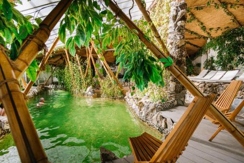 a swimming pool with a person in the water at Higina Spa Hotel in Truskavets