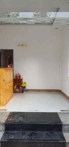 a room with a white wall and a white floor at S Villa Hotel in Da Thanh