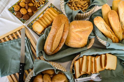 a bunch of different types of bread and snacks at Emerald Suites in Florina
