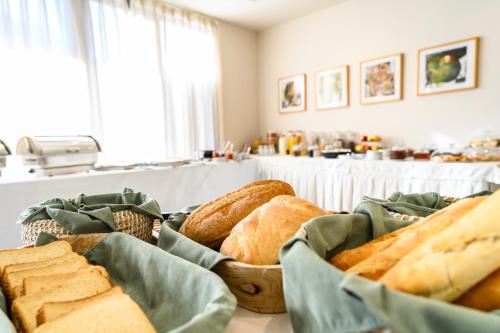 a bunch of different types of bread on a table at Emerald Suites in Florina