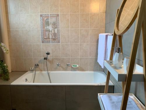 a bathroom with a bath tub with a sink at Kings View in Margate