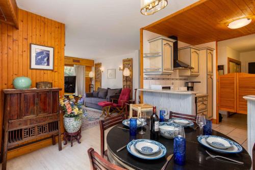 une cuisine et un salon avec une table et des chaises dans l'établissement Le Brevent apartment -Chamonix All Year, à Chamonix-Mont-Blanc
