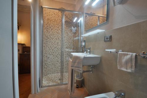 a bathroom with a shower and a sink at La Rughetta Guest House in Montepulciano
