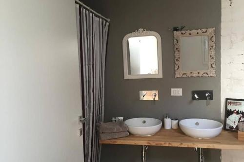a bathroom with two sinks and a mirror at Turin Loft7 in Turin