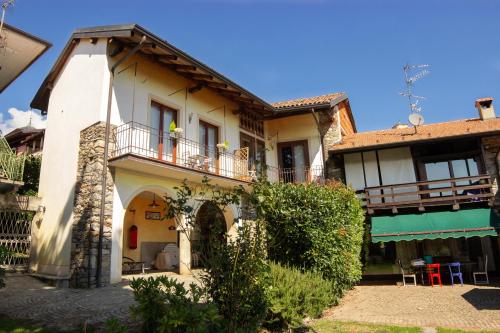 a house with a balcony on the side of it at Casa Patrone in Nebbiuno