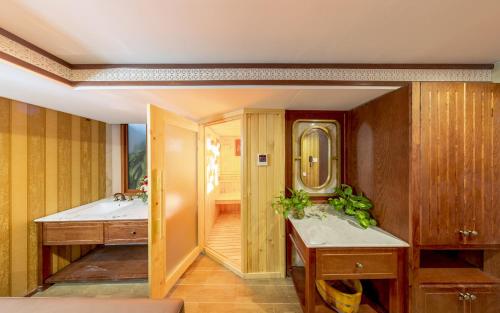 a bathroom with two sinks and a mirror at Athena Hotel Quy Nhơn in Quy Nhon