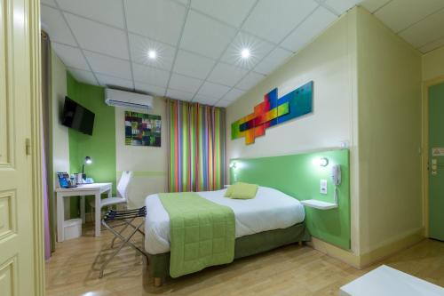 a hotel room with a bed and a desk and a table at La Commanderie de Champarey in Bourgoin