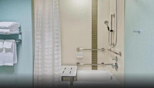 a bathroom with a shower and a sink at Hyatt Place Tulsa/Downtown in Tulsa