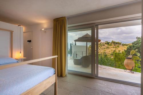 a bedroom with a bed and a large glass window at Casa Del Mandorlo in Noto