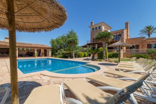 a group of lounge chairs and a swimming pool at Felanitx - 3029-85 Mallorca in Felanitx
