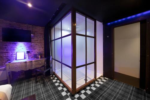 a bathroom with a large glass window and a sink at Briggate Hotel in Leeds