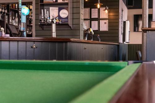a ping pong table in front of a bar at Fryatt Hotel & Bar in Harwich