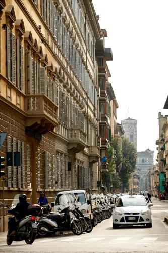 a group of motorcycles parked on a city street at Hotel Firenze Capitale in Florence