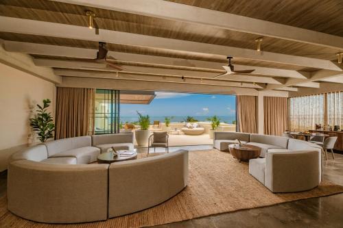 a large living room with couches and a table at Atelier Playa Mujeres- Adults Only - All Inclusive Resort in Cancún