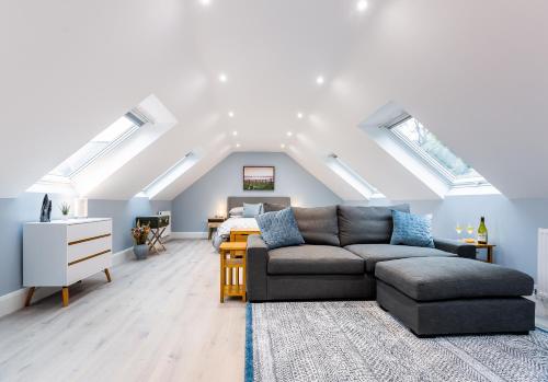 a living room with a couch and a bed at Rothbury Hideaway in Rothbury