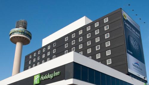 a hotel with a tower on top of a building at Holiday Inn Liverpool City Centre by IHG in Liverpool