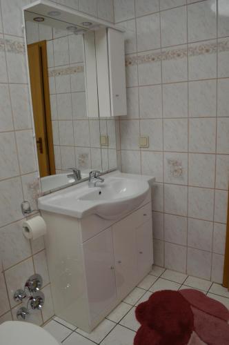 a bathroom with a white sink and a mirror at Am Klostergarten in Heilbad Heiligenstadt